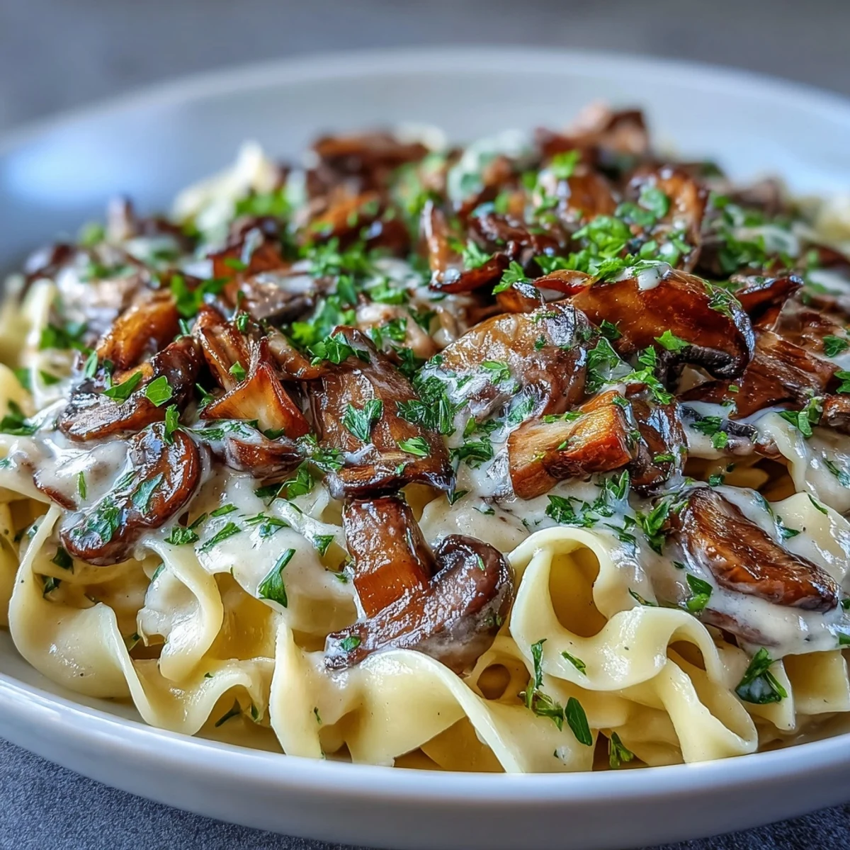 Ladle of Creamy Mushroom Stroganoff with sautéed mushrooms and egg noodles, perfect for a cozy dinner.