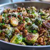Golden-brown Brussels sprouts and savory ground turkey mingle in a skillet, brightened with lemon and finished with a sprinkle of Parmesan and parsley.