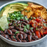 Colorful Plant-Based Taco Bowl topped with creamy avocado, ready to enjoy.