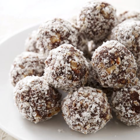 Close-up of decadent Mud Balls, rolled in powdered sugar, ready for a delicious, no-bake treat.