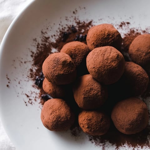 Decadent dark chocolate truffles coated in cocoa powder: a rich, melt-in-your-mouth dessert.