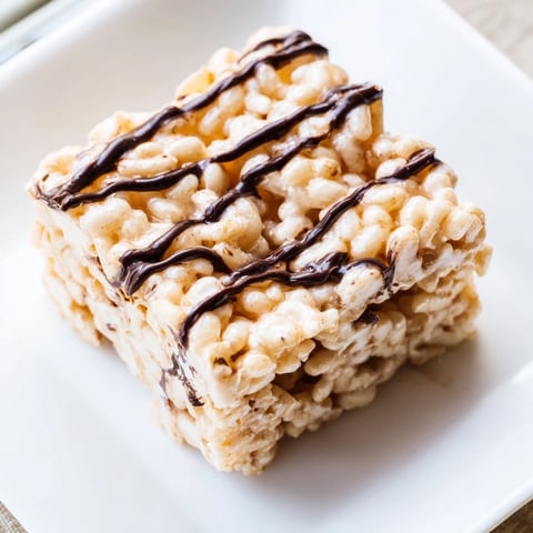 Chewy Rice Krispie Treats, a close-up showing perfectly golden squares, perfect for snacking.