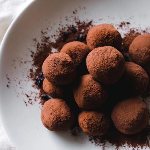 Decadent dark chocolate truffles coated in cocoa powder: a rich, melt-in-your-mouth dessert.