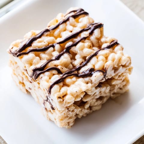 Chewy Rice Krispie Treats, a close-up showing perfectly golden squares, perfect for snacking.