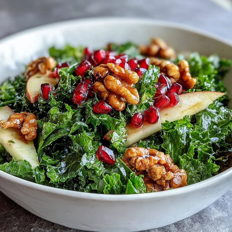Healthy Kale and Pomegranate Bowl plated with vibrant greens, bright pomegranate seeds, and walnuts, ideal for a quick vegetarian lunch or light side dish.