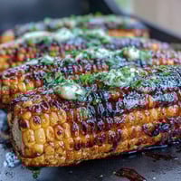 Grilled BBQ corn in foil with herb butter, tender and juicy with a burst of fresh parsley and thyme.